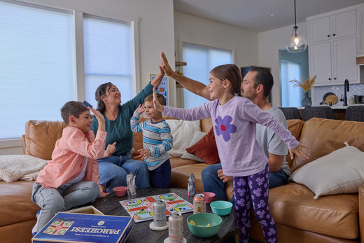 Family high fiving for setting New Years goals together