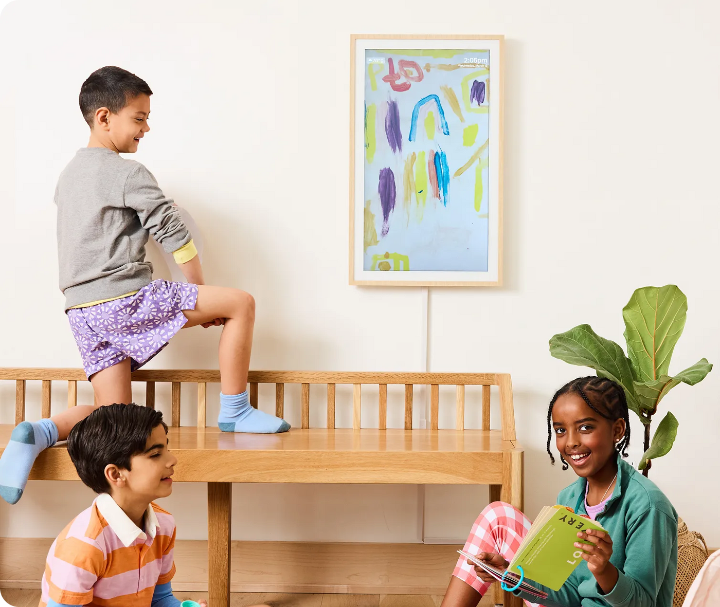 Children playing in a room with a colorful abstract painting on the wall.